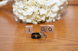 I DO - Photo of wedding bands and scrabble tiles.